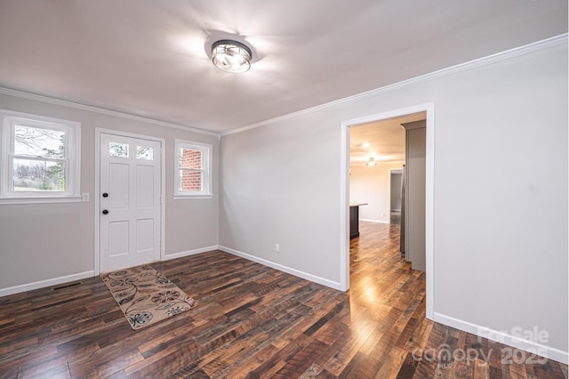 foyer featuring dark wood-style floors, a healthy amount of sunlight, and ornamental molding