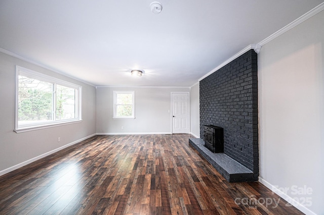 unfurnished living room with baseboards, a fireplace, dark wood-style floors, and crown molding