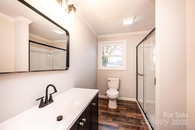 full bath with a shower stall, crown molding, toilet, wood finished floors, and vanity