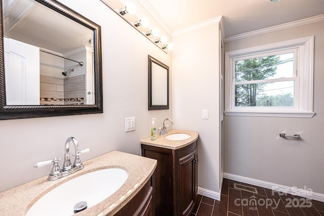 bathroom with ornamental molding, two vanities, baseboards, and a sink