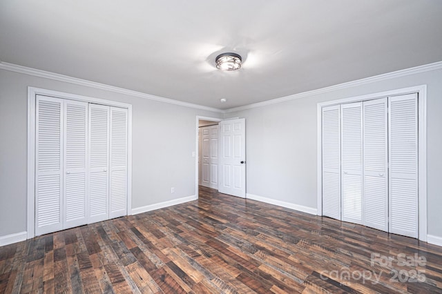 unfurnished bedroom featuring baseboards, ornamental molding, and dark wood-style flooring