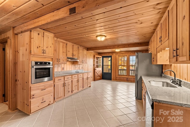 kitchen with a sink, under cabinet range hood, appliances with stainless steel finishes, light tile patterned floors, and wood ceiling