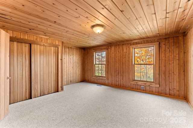 carpeted empty room with wooden ceiling and visible vents