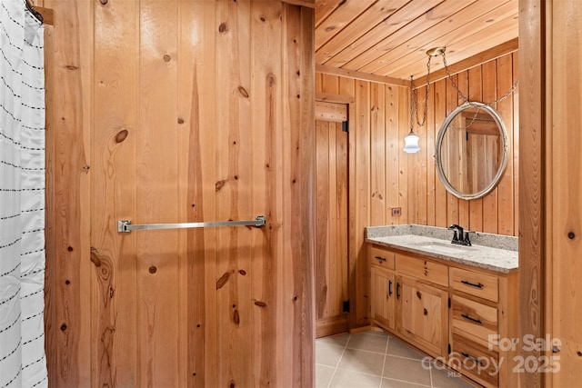 full bath featuring tile patterned flooring, wood ceiling, vanity, and wood walls