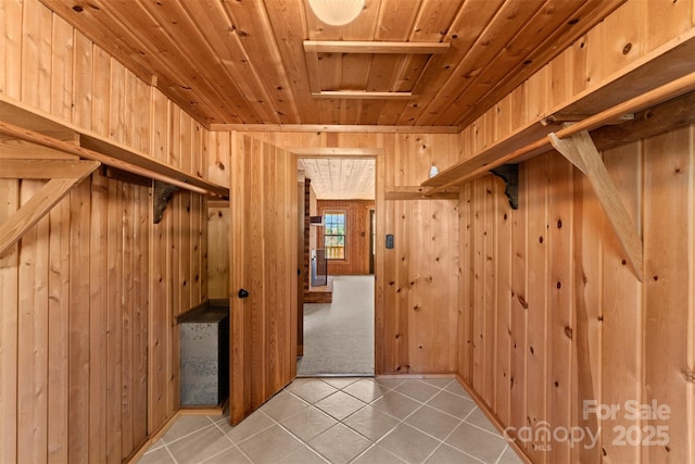 walk in closet with light tile patterned floors