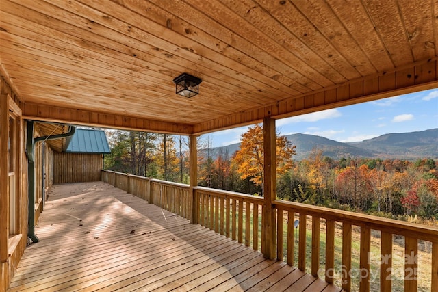 wooden terrace with a mountain view and a view of trees