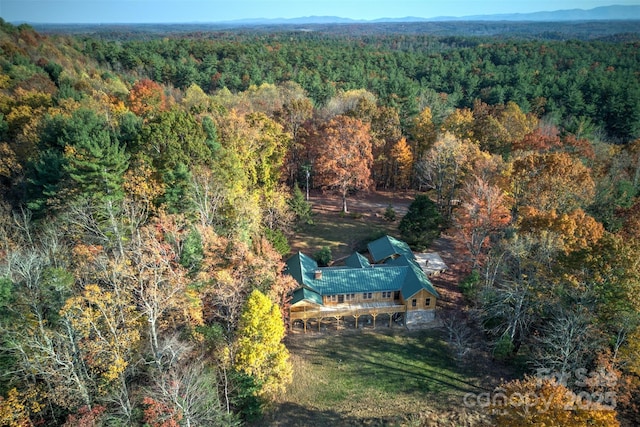 birds eye view of property featuring a wooded view