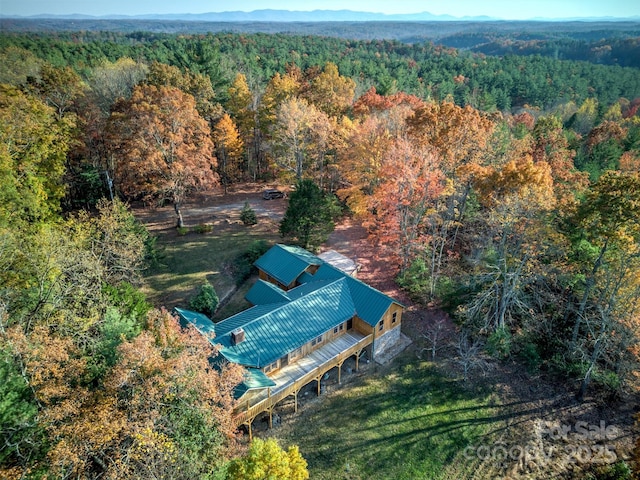 bird's eye view featuring a wooded view