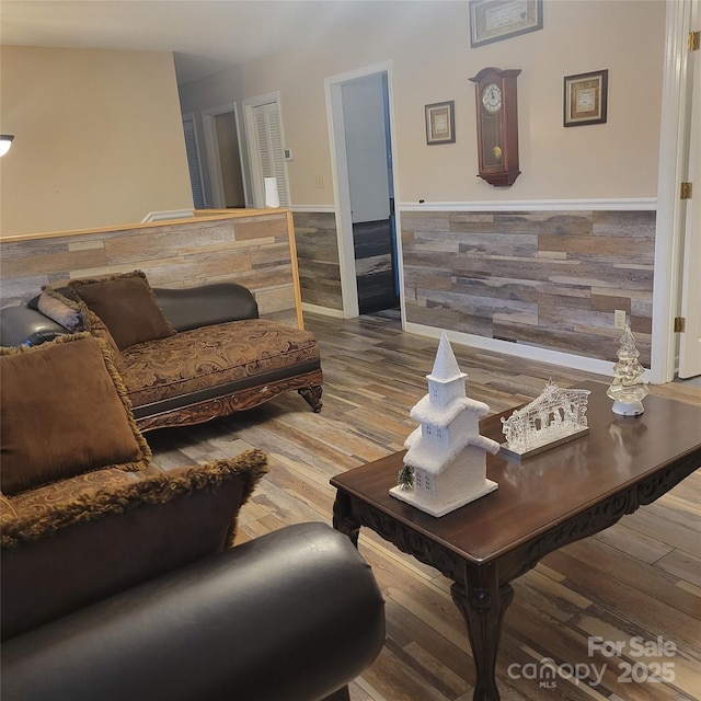 living room featuring wainscoting and wood finished floors