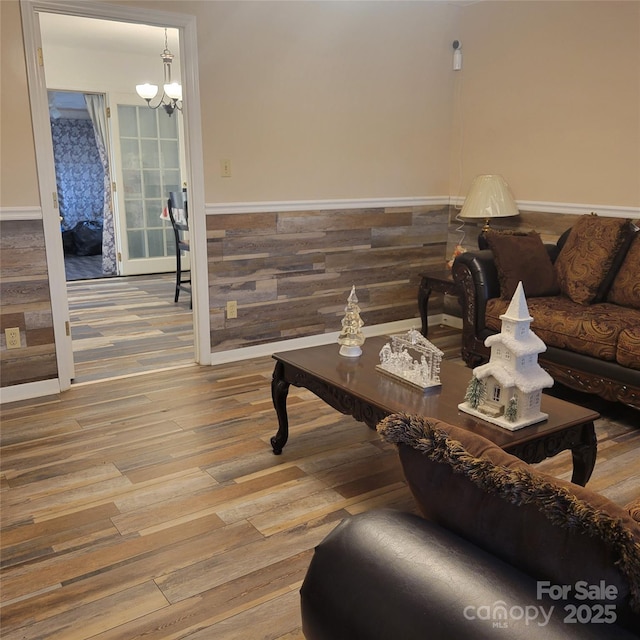 living room with an inviting chandelier and wood finished floors