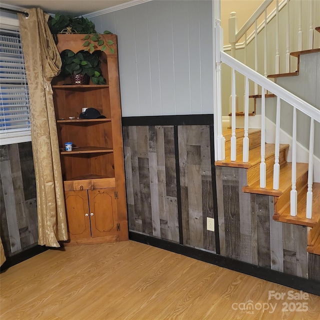 interior space featuring ornamental molding and wood finished floors