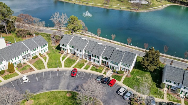 drone / aerial view featuring a water view and a residential view