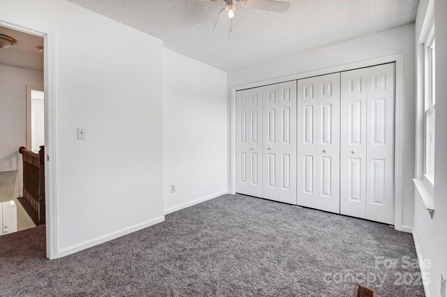 unfurnished bedroom with visible vents, baseboards, a textured ceiling, and carpet flooring