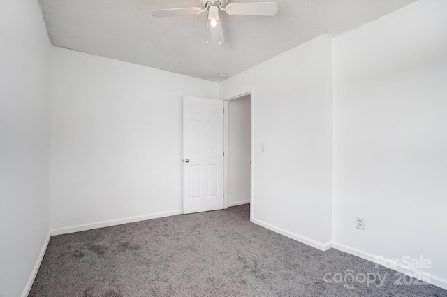 empty room featuring baseboards, ceiling fan, and carpet flooring