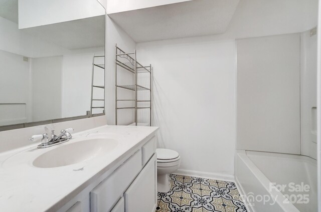 bathroom featuring vanity, tile patterned floors, toilet, and baseboards