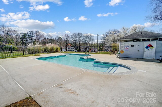 pool featuring a patio and fence