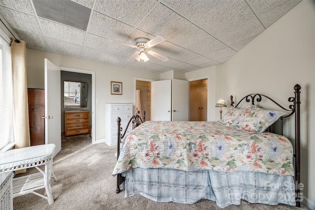 bedroom with a paneled ceiling, carpet, and ceiling fan