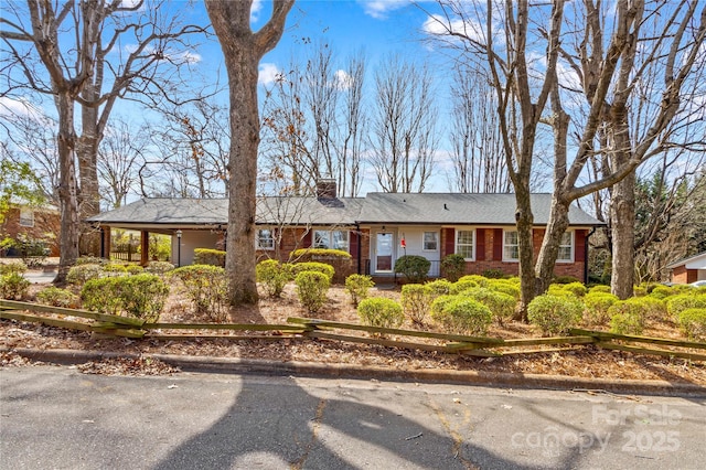 single story home with brick siding and a chimney