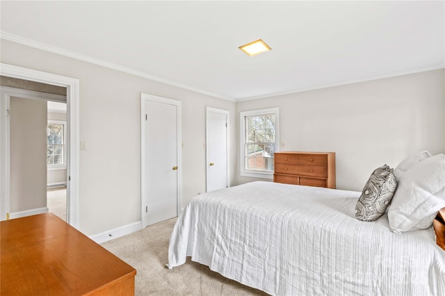 carpeted bedroom with baseboards and ornamental molding