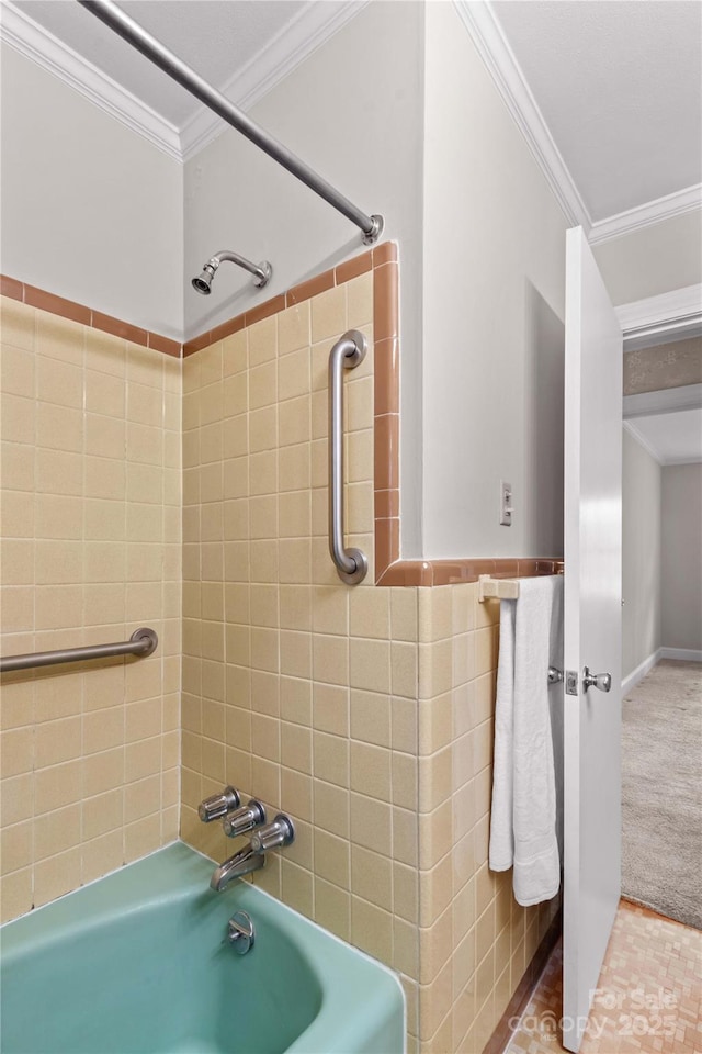 bathroom with a wainscoted wall, tile walls, shower / bathtub combination, and ornamental molding