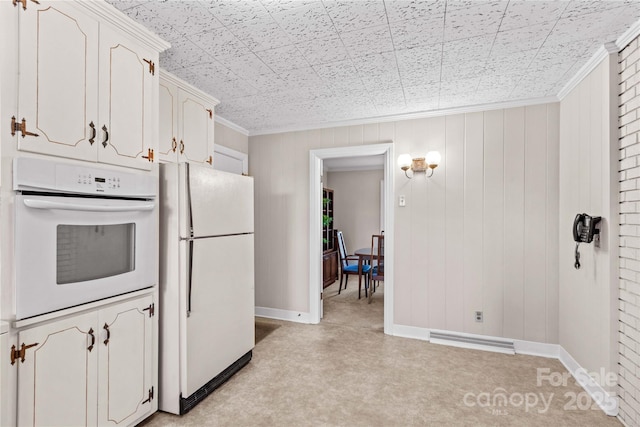 kitchen with white appliances, visible vents, baseboards, and ornamental molding