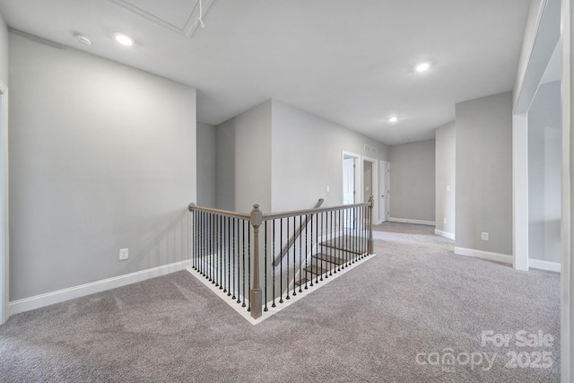 corridor featuring an upstairs landing, carpet flooring, recessed lighting, and baseboards