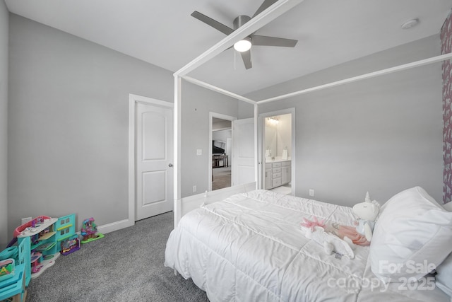 carpeted bedroom featuring baseboards, ensuite bathroom, and ceiling fan