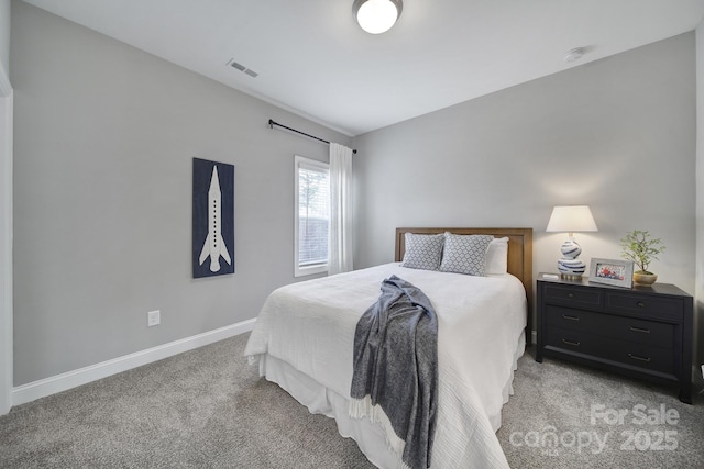 bedroom with visible vents, light colored carpet, and baseboards