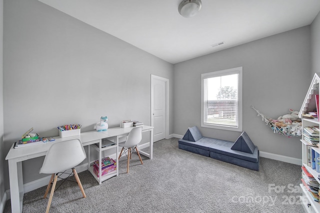 carpeted office space with visible vents and baseboards