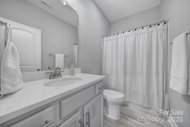 bathroom featuring visible vents, toilet, vanity, and shower / bath combo with shower curtain