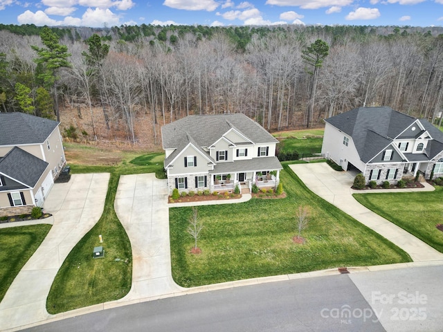 bird's eye view featuring a wooded view