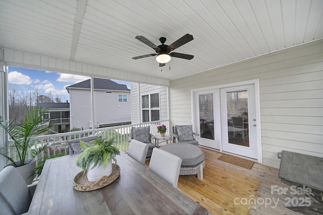 deck with outdoor dining space and a ceiling fan