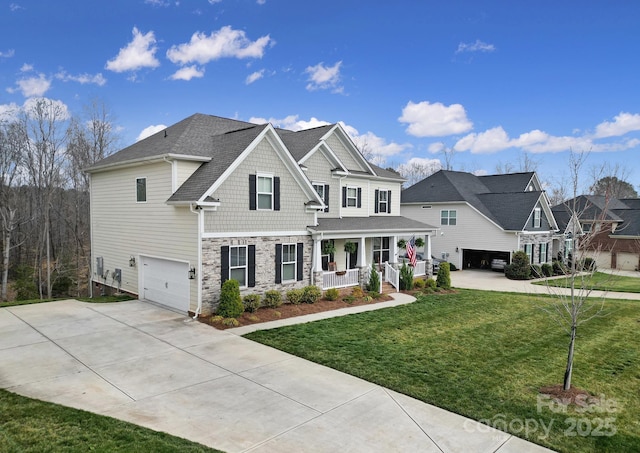 view of front facade featuring a porch, stone siding, an attached garage, and driveway