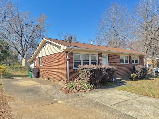 ranch-style home with brick siding, driveway, and crawl space