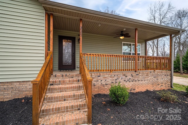 view of exterior entry featuring a porch and a ceiling fan