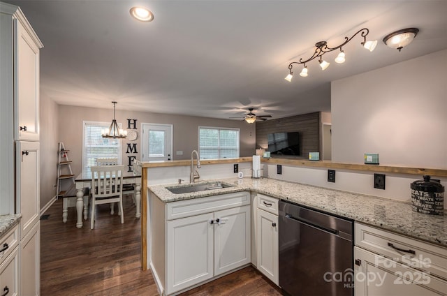 kitchen featuring dark wood-style flooring, a healthy amount of sunlight, dishwasher, and a sink