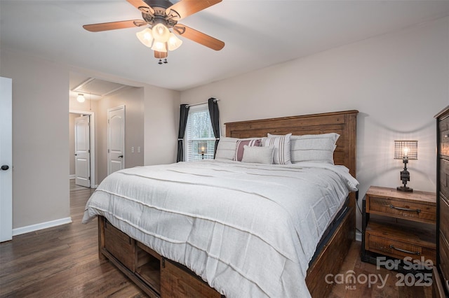 bedroom with ceiling fan, baseboards, attic access, and wood finished floors