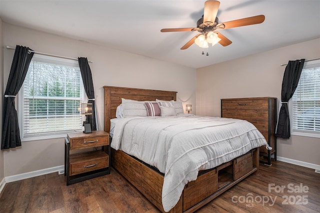 bedroom with baseboards, multiple windows, and dark wood finished floors