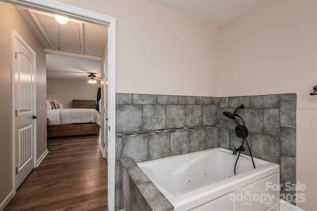 bathroom featuring wood finished floors, a whirlpool tub, and connected bathroom