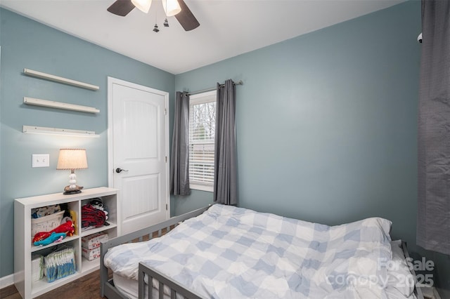 bedroom with a ceiling fan and baseboards