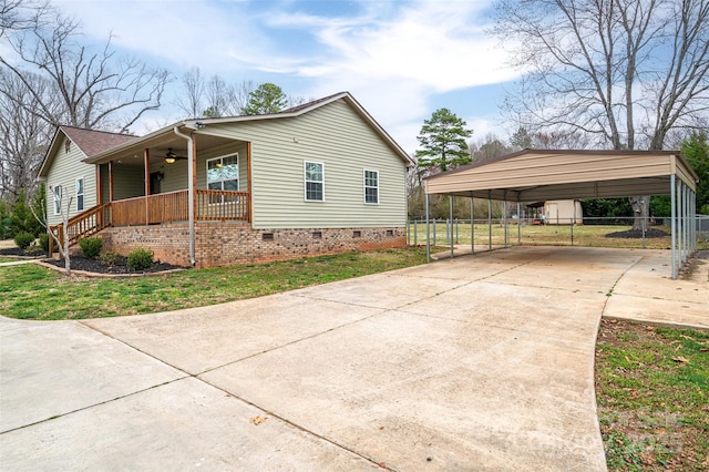 view of property exterior with a detached carport, a ceiling fan, covered porch, concrete driveway, and crawl space