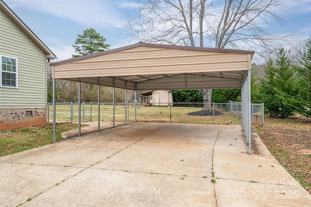 view of vehicle parking featuring a carport, concrete driveway, and fence