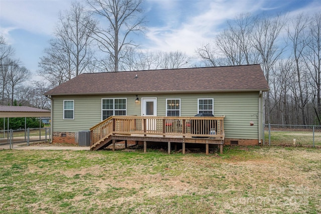 back of house featuring fence, a carport, a lawn, crawl space, and a gate