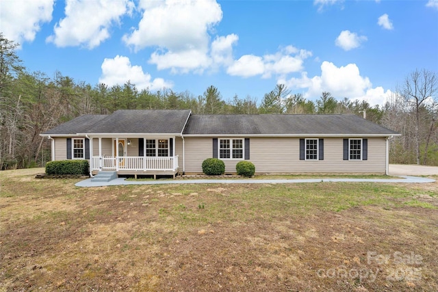 ranch-style home with a porch and a front yard