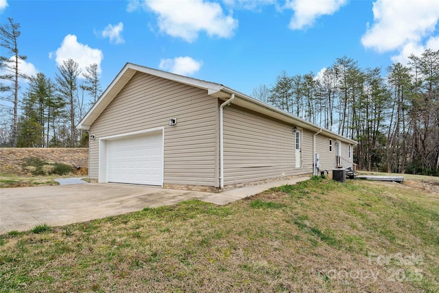 view of side of property with central air condition unit, a lawn, driveway, and a garage