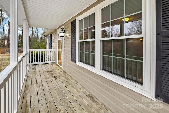 wooden terrace featuring covered porch