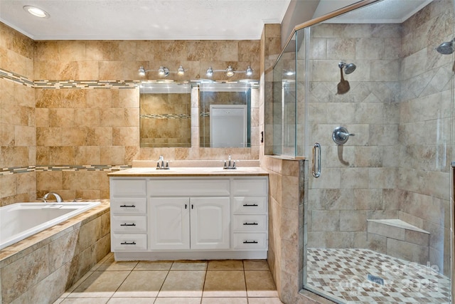 full bathroom featuring tile patterned floors, a garden tub, a textured ceiling, a shower stall, and vanity