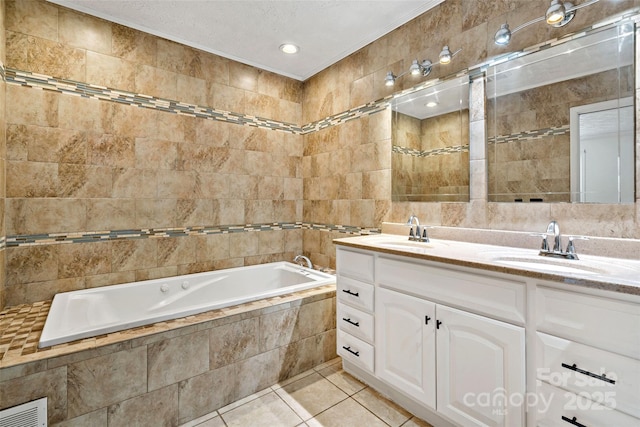 full bathroom with a sink, tile walls, a bath, and tile patterned flooring