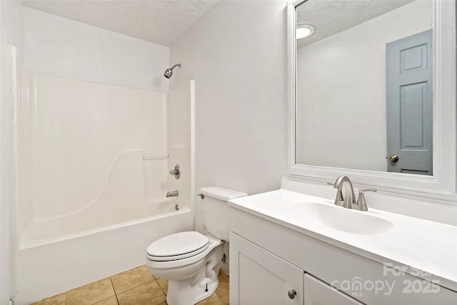 bathroom with tile patterned floors, toilet, vanity, and a textured ceiling