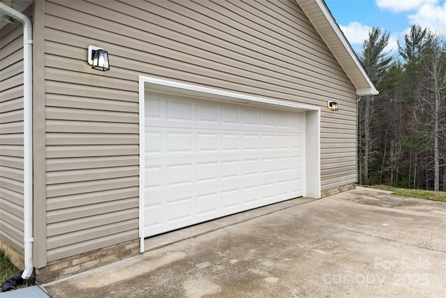 garage featuring concrete driveway